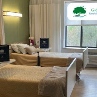 A well-lit hospital room with two patient beds, equipped for comfort and care.