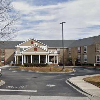 A mid-sized hotel with a prominent entrance and circular driveway.