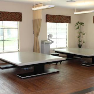 A spacious room featuring modern tables and ample natural light.