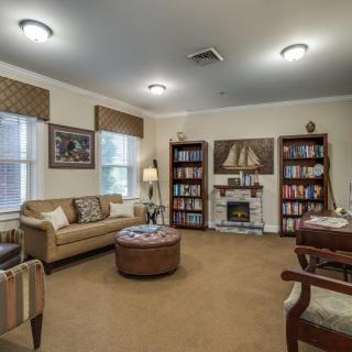 A cozy living room with bookshelves and comfortable seating.