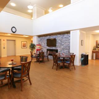 Spacious lobby area with seating and a fireplace.