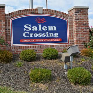 Welcome sign for Salem Crossing, a residential community, featuring brick landscaping.