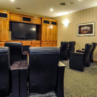 A cozy home theater setup with comfortable seating and a large screen for entertainment.