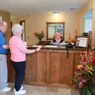 Two guests checking in at a hotel reception.