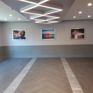 A modern gallery space showcasing photographs on the walls under artistic lighting.