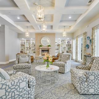 A stylish living room with patterned armchairs and a cozy fireplace.