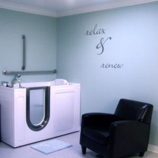 A modern bathroom with a walk-in bathtub and comfortable seating.