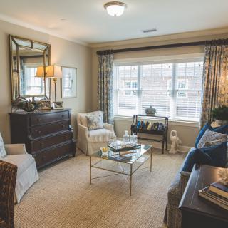 A cozy and well-lit living room with stylish furniture and decor.
