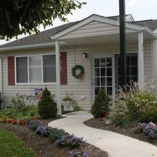 A cozy house with a landscaped front yard and a welcoming pathway.