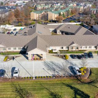 Aerial view of a suburban building with a parking lot.