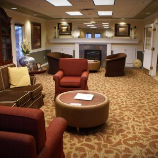 A cozy lobby area featuring comfortable seating and a fireplace.
