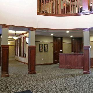 An indoor reception area with wooden accents and a carpeted floor.
