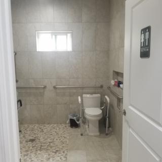 An accessible bathroom with a shower and grab bars.