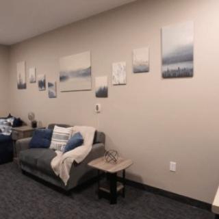 A cozy living room with a sofa and minimalist wall art decor.