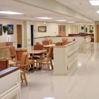 A clean and well-organized hospital corridor with seating arrangements.