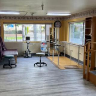 A physical therapy room equipped with exercise equipment and rehabilitation tools.