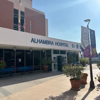 The entrance of Alhamera Hospital, a healthcare facility under clear skies.