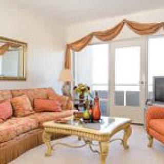A traditional style living room with a cozy sofa and elegant coffee table.