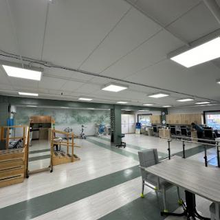 A spacious and well-equipped physical therapy room designed for rehabilitation exercises.