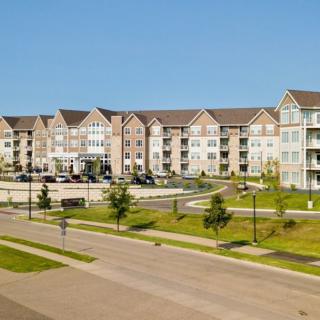 A modern suburban apartment complex with landscaped surroundings.