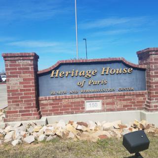 Heritage House sign with a clear blue sky in the background.