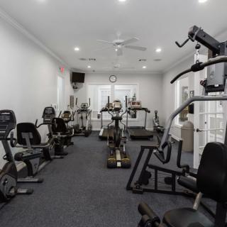 A well-equipped gym featuring a variety of exercise machines and equipment.