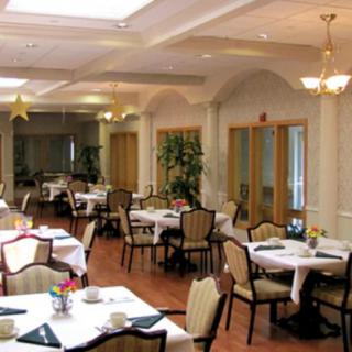 An elegantly decorated dining room with neatly arranged tables and chairs.