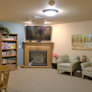 A cozy living room with a fireplace, TV, and comfortable seating.