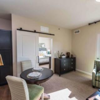 A cozy apartment living room with a dining area and modern furnishings.