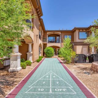 Outdoor shuffleboard court surrounded by a building and landscape.