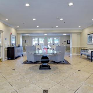 A spacious and well-lit lobby area with modern seating and tiled flooring.