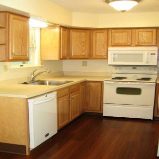 A kitchen with wooden cabinets and modern appliances.