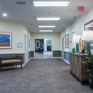 A well-lit hallway with decorative elements and seating.