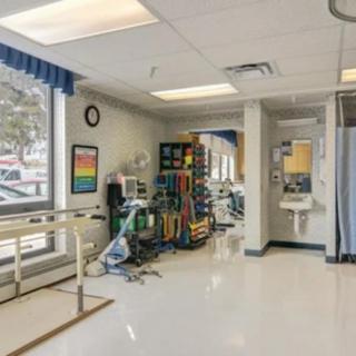 A well-equipped rehabilitation room with medical devices and a clean, organized setup.