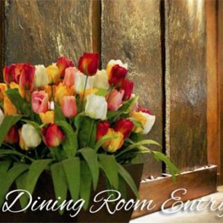 A vibrant bouquet of tulips adds elegance to the dining room decor.