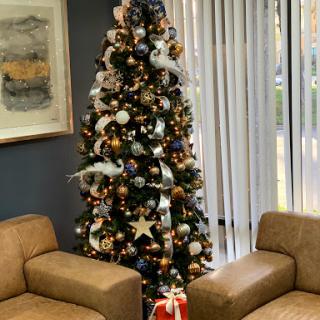 A beautifully decorated Christmas tree in a cozy living room setting.