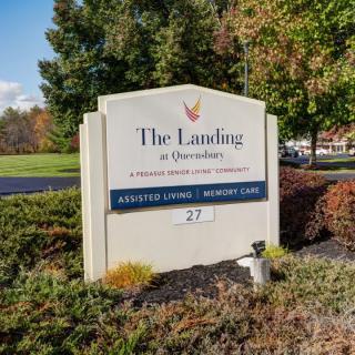 Sign for 'The Landing at Queensbury' indicating assisted living and memory care services.