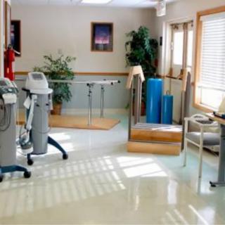 A well-equipped physical therapy room featuring various rehabilitation equipment and exercise machines.