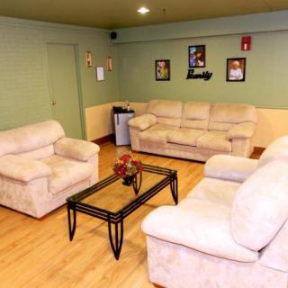 A cozy living room with beige sofas and a glass coffee table on a wooden floor.