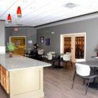 A modern dining area with a bar counter and stylish lighting.