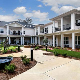 A modern residential building with well-maintained landscaping and outdoor walkways.