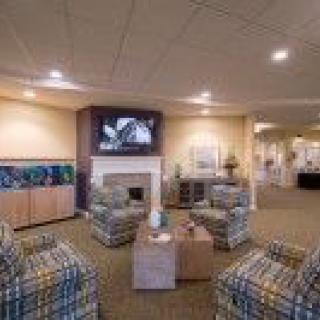 A cozy living room featuring a fireplace, television, and comfortable seating.