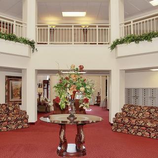 A well-decorated lobby with comfortable seating and elegant floral arrangements.