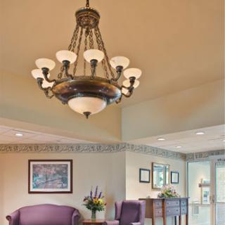 A beautifully designed chandelier illuminating a cozy living space.