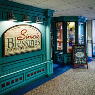Entrance to Simple Blessings Country Store with vibrant teal decor and signage.