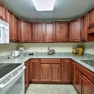A modern kitchen with wooden cabinets and stainless steel appliances.