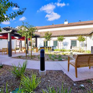 A tranquil outdoor space featuring benches and landscaped gardens, perfect for relaxation.