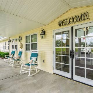 A welcoming entrance with glass doors and rocking chairs on the porch.