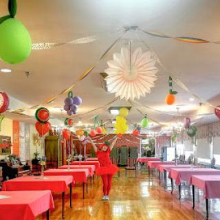 A vibrant party setup with colorful decorations and tables ready for guests.