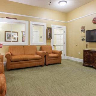 A cozy living room with comfortable sofas, a television, and decorative elements.